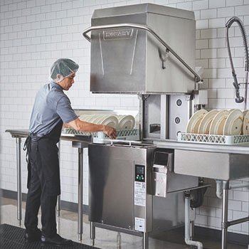 commercial-dish-washing-machine-restaurant Commercial dishwasher in the back of a restaurant to clean dishes.
